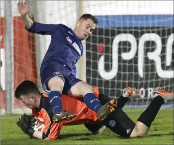  ??  ?? Newfoundwe­ll goalkeeper Ronan Brown and Boyne Harps striker Carl Dowling end up on the floor.