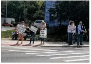  ?? WAYNE BAKER / STAFF ?? People supporting David Nibert’s efforts to save nine sheep being raised for food at Antioch College held protests this past weekend in the village of Yellow Springs.