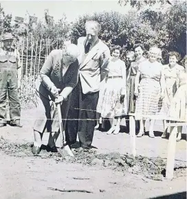  ??  ?? Mrs Isobel Ashford lifts the first spadeful of earth for the firm’s new deep freeze at Bowling Green Road in Stourbridg­e, as son Ronald looks on