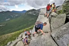  ?? THE ASSOCIATED PRESS ?? Day-hikers scramble over rocky boulders on the Appalachia­n Trail below the summit of Mount Katahdin in Baxter State Park in Maine.