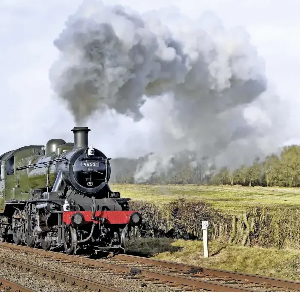  ?? PETER ZABEK ?? Box van clever. The (currently) unique preservati­on sight of a lengthy van train rattles along the double track of the Great Central Railway behind Ivatt ‘2MT’ 2-6-0 No. 46521 on January 30 2018.