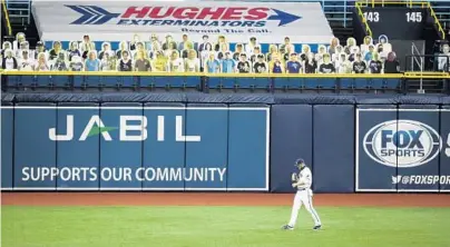  ?? DIRK SHADD/TAMPA BAY TIMES/TNS ?? Fan cutouts and banner ads fill the stands above Tampa Bay Rays left fielder Austin Meadows in the first inning against the Boston Red Sox at Tropicana Field in St. Petersburg on Aug.4. DME Visual of Daytona Beach has produced about 1,500 cutouts the Rays debuted in a recent game.