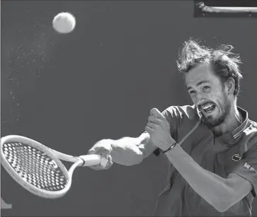  ?? Photograph­s by Mark J. Terrill Associated Press ?? DANIIL MEDVEDEV returns a shot against American Frances Tiafoe during the Russian’s 7-5, 7-6 (4) semifinal win at the BNP Paribas Open in Indian Wells. Medvedev won his 19th straight match victory of the year.