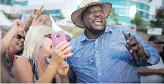  ??  ?? Sugar Ray Rayford wades into the crowd to get up close and personal at the LiUNA Bluesfest Windsor on Saturday.