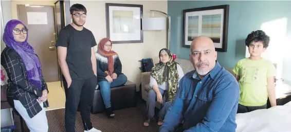  ?? GRAHAM HUGHES, THE CANADIAN PRESS ?? Tauseef Bhatti and his wife, Weena Sehar, sit with their children Bia, Aadn, Tuba and Minah, in a Montreal hotel room. The family has been staying at the hotel more than six months after their home was flooded. “There’s no privacy, it’s very...