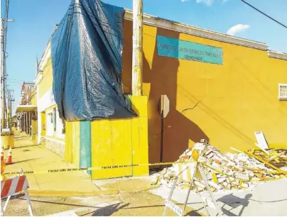  ?? STAFF PHOTO BY TIM OMARZU ?? A pile of bricks and yellow caution tape outside Vintage and More on the Blvd on Tuesday is a reminder of the June 8 accident when a sport-utility vehicle crashed through the exterior brick wall.