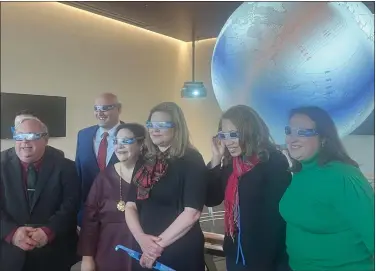  ?? ERICA BOUSKA — MEDIANEWS GROUP ?? Some of the commission­ers in the task force posing after Monday’s press conference with I LOVE NY eclipse glasses in front of the Science-On-A-Sphere room depicting the path of totality for the eclipse April 8.