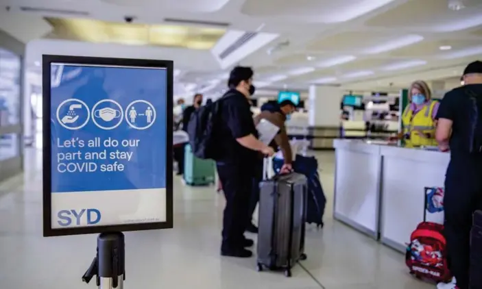  ?? Photograph: Xinhua/REX/Shuttersto­ck ?? Passengers line up for Covid check at Sydney airport in Sydney. The new Omicron variant has been confirmed in Australia.