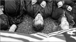  ?? ZACH GIBSON/GETTY IMAGES ?? Demonstrat­ors lie on the ground near the White House on Monday to symbolize the 17 who died at Marjory Stoneman Douglas High and to call for stronger gun controls.