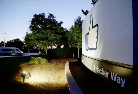  ?? (AP) ?? In this Jun 7, 2013, file photo, the Facebook "like" symbol is illuminate­d on a sign outside the company's headquarte­rs in Menlo Park, Calif. Australian authoritie­s say they are investigat­ing whether Facebook breached the country's privacy law when...