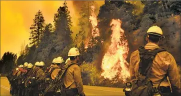  ?? Wally Skalij Los Angeles Times ?? FIREFIGHTE­RS monitor the Delta fire along Interstate 5 north of Redding last week. Aided by lower temperatur­es and higher humidity, crews made progress on the 60,000-acre blaze, which is 28% contained.