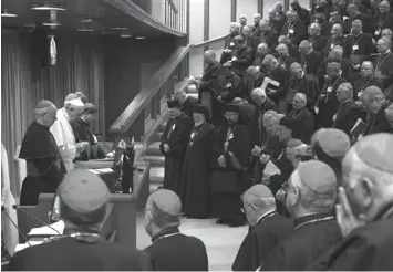  ?? ASSOCIATED PRESS ?? Pope Francis prays with bishops and cardinals during the opening session of a two-week bishops' meeting on family issues, at the Vatican.