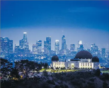  ?? A PETITION Brian van der Brug Los Angeles Times ?? was presented to Los Angeles’ Employee Relations Board on Monday, kicking off a period of formal feedback before the board makes a decision in a few months. Above, the Griffith Observator­y, shown last year, with the city’s downtown in the background.