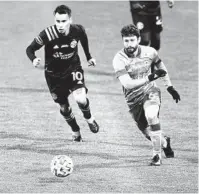  ?? JAY LAPRETE AP ?? Columbus’ Lucas Zelarayan (left) and Seattle’s Joao Paulo chase the ball during the first half of the MLS Cup.