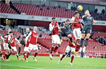  ??  ?? Aubameyang (second right) heads the ball toward the goal and into his own net to score an own goal. - AFP photo