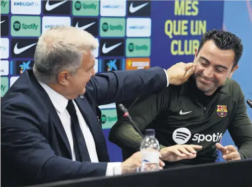  ?? ALBERT GEA/REUTERS ?? ▲ Xavi (right) with Barcelona’s president, Joan Laporta, who said: ‘I was always clear that I wanted him to continue’