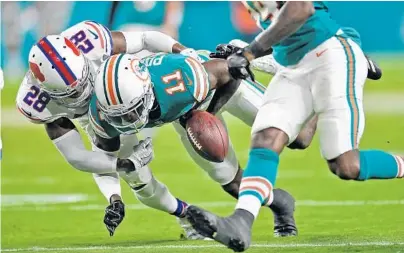  ??  ?? Dolphins wide receiver Jarvis Landry (14) fumbles after being hit by Bills cornerback E.J. Gaines (28). The Dolphins would recover.