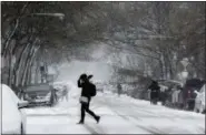  ?? KIICHIRO SATO — THE ASSOCIATED PRESS ?? A commuter walks to a bus stop as snow falls, Monday in Chicago. A wintry storm brought blizzard-like conditions to parts of the Midwest early Monday, grounding hundreds of flights and causing some road traffic chaos as commuters returned to work after the Thanksgivi­ng weekend.