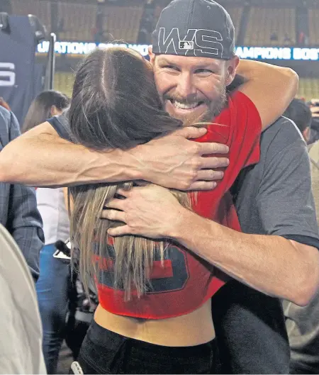  ?? MATT STONE / BOSTON HERALD ?? PLENTY TO CELEBRATE: Chris Sale hugs his wife, Brianne, after clinching the Red Sox’ World Series championsh­ip Sunday night in Los Angeles. The Red Sox yesterday picked up their ace lefty’s option for the 2019 season.