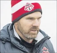  ?? CP PHOTO ?? Toronto FC head coach Greg Vanney walks to the field during practice ahead of the MLS championsh­ip final match against the Seattle Sounders in Toronto in December 2016. Toronto FC leaves the snow for the warmth of Florida on Monday, kicking off the...