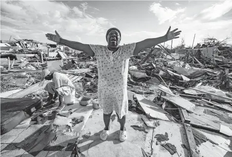  ?? AL DIAZ adiaz@miamiheral­d.com ?? Aliana Alexis of Haiti stands on the concrete slab of what is left of her home after destructio­n from Hurricane Dorian in an area called “The Mud” at Marsh Harbour in Great Abaco Island, Bahamas, on Sept. 5, 2019.