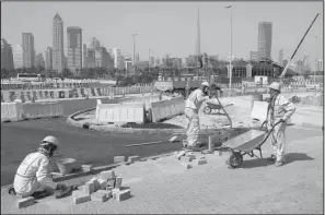  ?? AP/KAMRAN JEBREILI ?? A few laborers work on a road constructi­on site in Dubai, United Arab Emirates, last week.