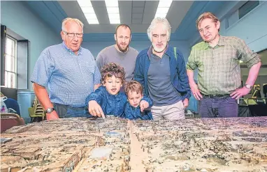  ?? Pictures: Steve MacDougall. ?? Left: Marley and Casper Anderson with grandfathe­r Bob, dad Colin, Alastair McClymont and David Campbell look at a diorama in the Crieff Remembers festival. Above: artefacts related to Charles Maitland Makgill Crichton.