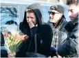  ??  ?? An emotional fan arrives to lay flowers outside Michael’s north London home