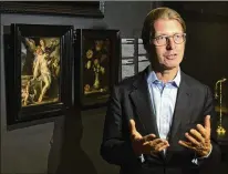  ?? ASSOCIATED PRESS ?? Taco Dibbits, director of Rijksmuseu­m, discusses Bartholome­us Spranger’s “Body of Christ Supported by Angels” oil on copper painting (left), a gift received to underscore support for coronaviru­s victims and museums in crisis worldwide.