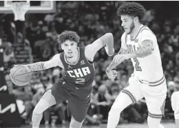  ?? JONATHAN DANIEL GETTY IMAGES ?? Hornets’ LaMelo Ball drives against his brother Lonzo Ball of the Bulls.