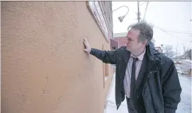  ?? ROBERT AMYOT/MONTREAL GAZETTE FILES ?? Kristian Gravenor inspects a wall of the dépanneur he owns in Ste-Annede-Bellevue in 2014.