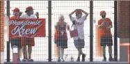  ?? Matt Slocum / Associated Press ?? Phillies fans watch from an outfield gate during an Aug. 5 game against the Yankees in Philadelph­ia. The “Phandemic Krew” are the Phillies’ biggest fans.