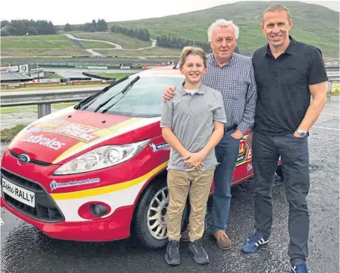  ?? ?? DYNASTY: A young Max McRae with father Alister and grandad Jimmy at Knockhill for his first taste of rallying.