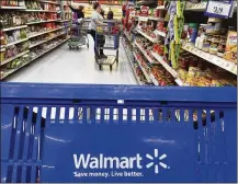  ?? ELISE AMENDOLA / AP 2017 ?? Customers shop for groceries at a Salem, N.H., Walmart. The Arkansas retailer’s sales rose to $136.3B.