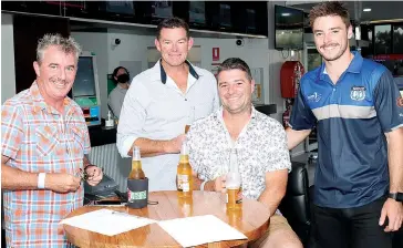  ?? ?? Working out their tips for the first race at the Warragul Cup are the “4 dog syndicate” (from left) Matt Pyle, Paul Hughes, Matt Irwin and Toby Bransgrove.