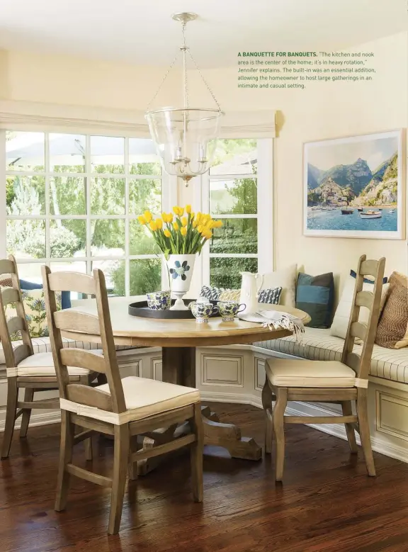  ??  ?? A BANQUETTE FOR BANQUETS. “The kitchen and nook area is the center of the home; it’s in heavy rotation,” Jennifer explains. The built-in was an essential addition, allowing the homeowner to host large gatherings in an intimate and casual setting.