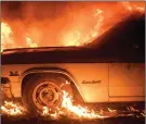  ?? The Associated Press ?? Flames from a wildfire consume a car near Oroville, Calif., on Saturday.