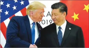  ??  ?? US President Donald Trump meets with China’s President Xi Jinping at the start of their bilateral meeting at the G20 leaders summit in Osaka, Japan on June 29. China and the US have agreed to roll back tariffs on each other’s goods in phases as they work toward a deal between the two sides, a Ministry of Commerce spokesman said yesterday.