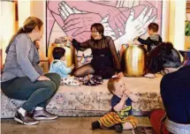  ?? Amaya Edwards/The Chronicle ?? Ruth Grace Wong (center) talks to Lena Miyamoto while their children play during a Joyful Parenting SF meetup at Manny’s.