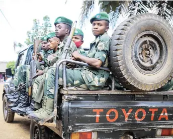  ?? Photo — AFP ?? Soldiers of the Armed Forces of the Democratic Republic of Congo (FARDC) are seen on a patrol vehicle in Beni.