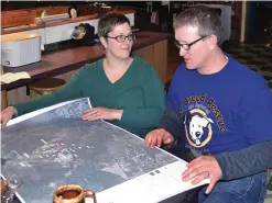  ??  ?? HANOVER, New Hampshire: In this photo, Debbie and Richard Higgins, whose well water has been contaminat­ed by a suspected carcinogen from a Dartmouth dump site, look at a map on their kitchen table in Hanover, N.H., which shows where the contaminat­ion...