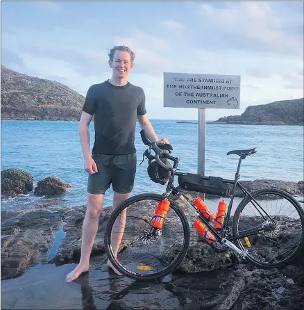  ??  ?? READY TO RIDE: Horsham’s Tom Dunn prepares for the first leg of his Australia’s Longest Triathlon challenge, at the northernmo­st point of Australia, Cape York.