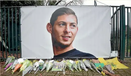  ?? AP ?? Flowers and tributes are placed near a giant picture of Emiliano Sala outside FC Nantes’ training ground.
