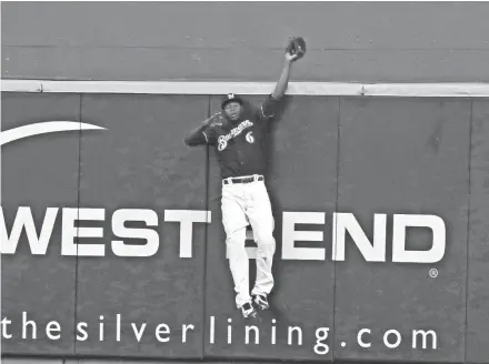  ??  ?? Lorenzo Cain robs David Freese of a home run in the first inning Saturday.