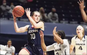  ?? Gary Landers / Associated Press ?? UConn guard Nika Muhl (10) looks to pass over Xavier guard Aaliyah Dunham (3) during the first half on Saturday.