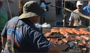  ?? PHOTO TOM BODUS ?? A member of Los Camperos team works the grill at the third annual Brawley elks Lodge Rib Cook-off on saturday.