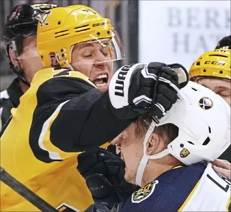  ?? Peter Diana/Post-Gazette photos ?? Evgeni Malkin fights Buffalo’s Curtis Lazar in the third period of the Penguins’ 5-2 loss to the Sabres at PPG Paints Arena.