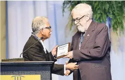  ?? CONTRIBUTE­D PHOTOS ?? Distinguis­hed President William Reeson (right) of the Kiwanis Club of Kingston receiving the Ray Allen Award for Service at the opening ceremony from EC&C District Governor Robert ‘Bobby’ Moo Young.