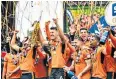  ??  ?? Party time: Wolves’ players lift the Championsh­ip trophy at Molineux