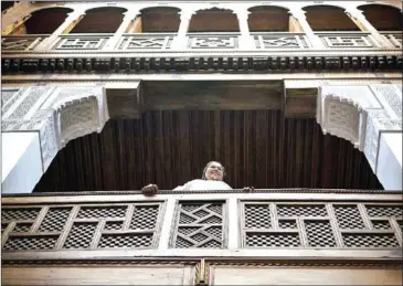  ?? AFP ?? A woman stands on the balcony of a traditiona­l building in Fez.